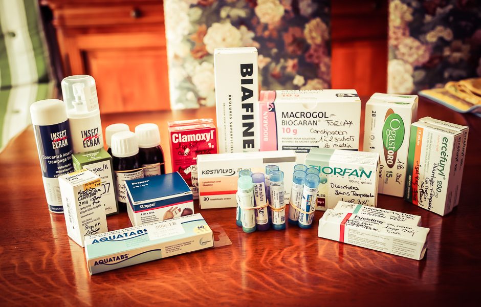 Médicaments de notre trousse à pharmacie de voyage étalés sur une table