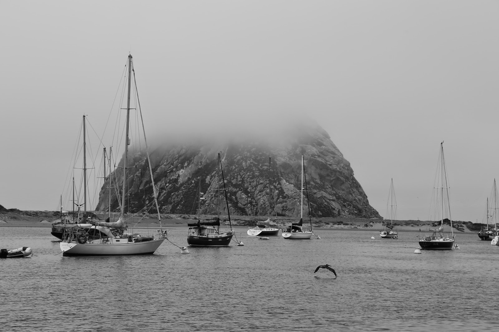 Le Morro Rock dans la brume et les voiliers de la baie