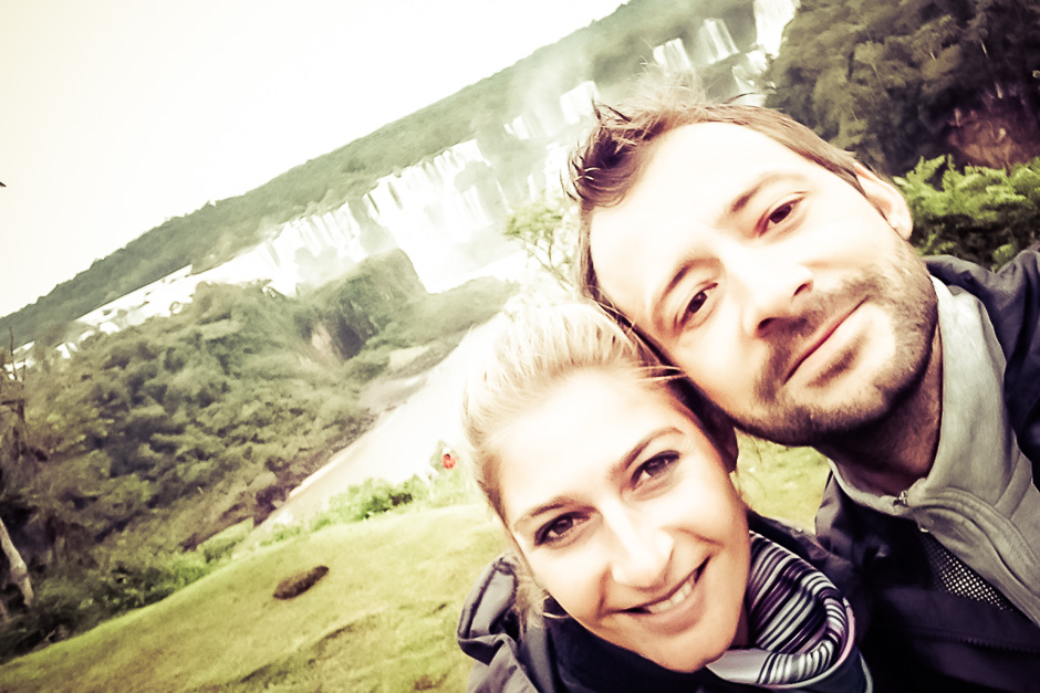 Selfie d’un couple de voyageurs devant des chutes d’eau